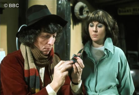 Tom as the Doctor examines a piece of equipment  watched by Elisabeth Sladen as Sarah Jane Smith.   Picture © BBC